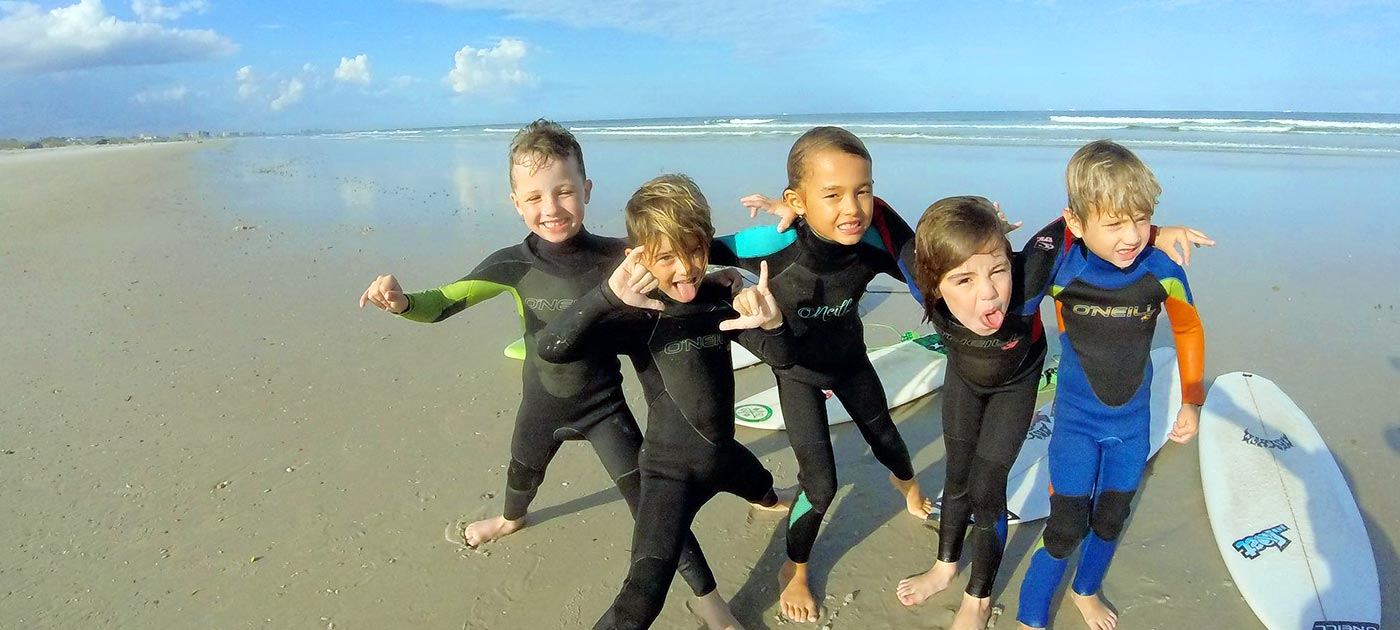 Variety of kid's wetsuits displayed in different sizes